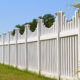 White vinyl fence with contemporary look surrounding a homes back yard
