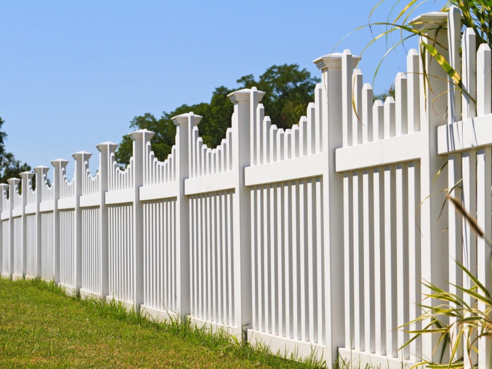 White vinyl fence with contemporary look surrounding a homes back yard